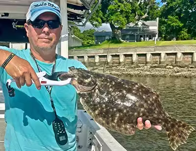 Captain Harvey Wall with a nice flounder from Ocean Isle Beach Captain Harvey Wall with a nice flounder from Ocean Isle Beach