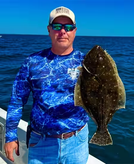 Captain Harvey Wall with a Flounder caught near Ocean Isle Beach