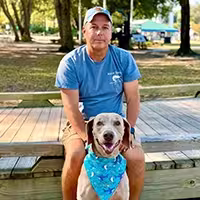 Captain Harvey Wall with his dog Oakley in Sunset Beach Park