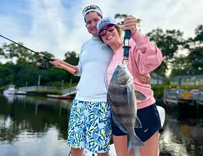 Angler holding a black drum in Ocean Isle Beach, NC