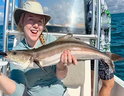 Experience exciting Cobia fishing in Ocean Isle Beach! Happy angler with Cobia caught near Ocean Isle Beach