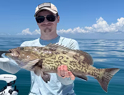 Book Salty Dawg Fishing Charters for your nearshore fishing charter and catch Grouper in Ocean Isle Beach, NC! Angler with a keeper Gag Grouper caught on an OIB nearshore fishing charter