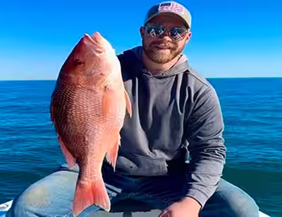 Angler holding a red snapper in Ocean Isle Beach, NC