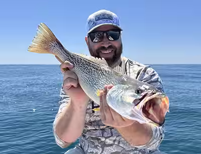 Fishing charter client with a nice Gray Trout (Weakfish) caught in OIB