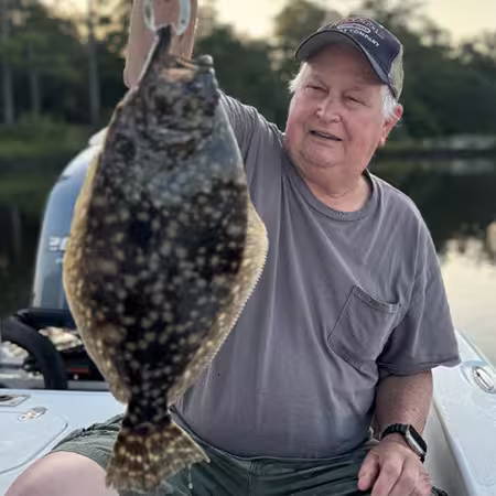 angler holding a flounder caught in OIB