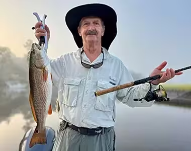 Charter fishing customer with nice Redfish in Ocean Isle Beach