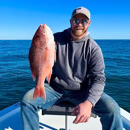 Angler holding a red snapper in Ocean Isle Beach