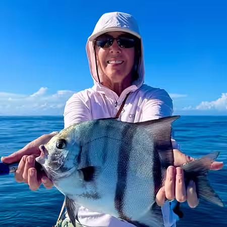 Female angler holding a large Atlantic Spadefish caught near Ocean Isle Beach, NC