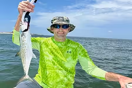 Angler holding Spanish Mackerel in Ocean Isle Beach NC