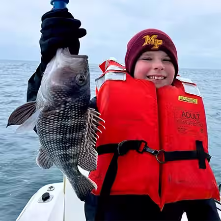 Keeper Sea Bass caught by young angler in OIB